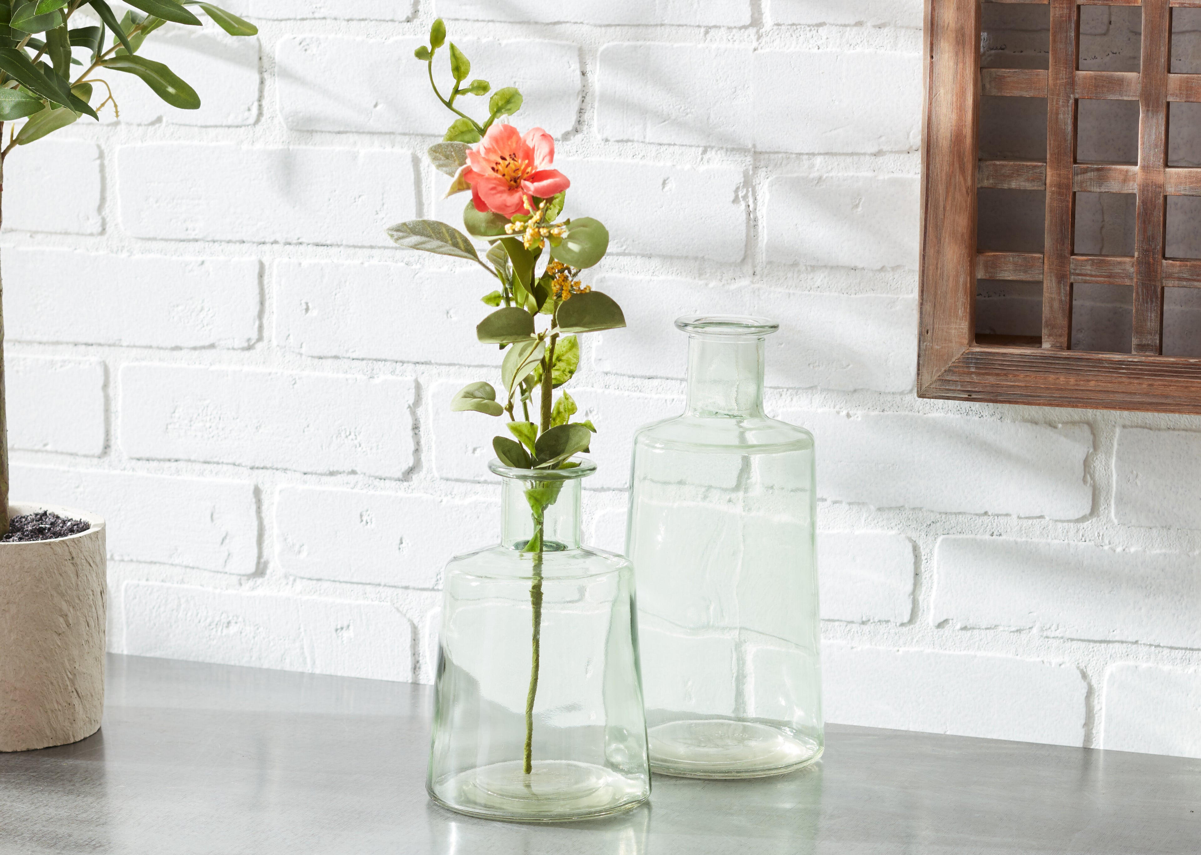 green glass bottle vases on a table top